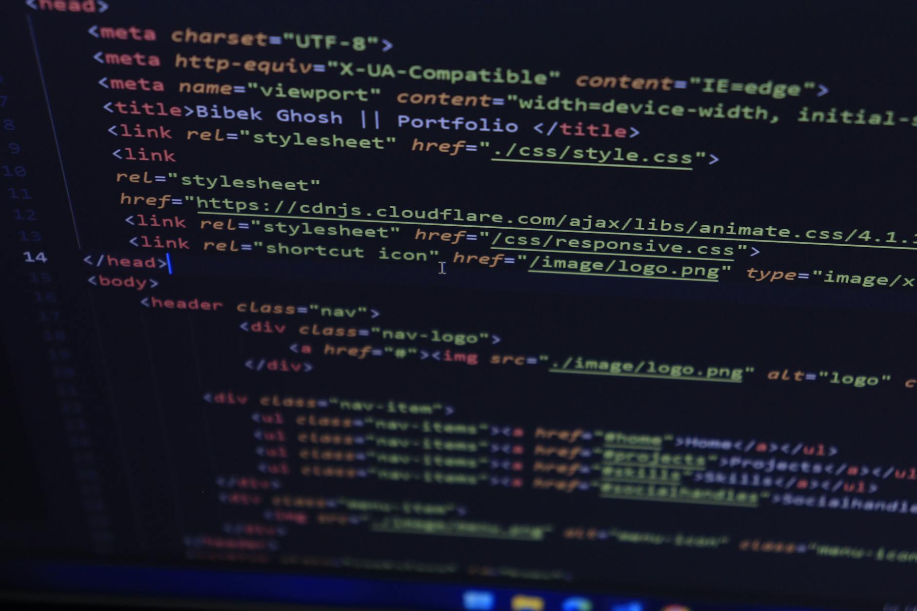 Developer coding HTML and CSS for Brisbane web design agency projects on desktop monitor