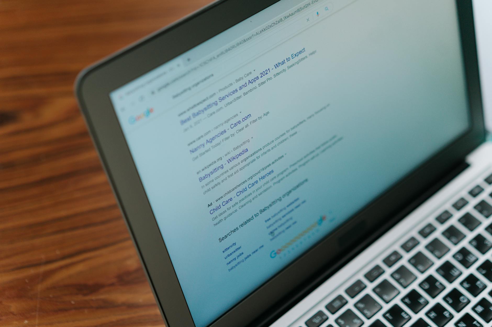 Small business owner reviewing Google Ads budget dashboard on laptop screen for monthly spending analysis