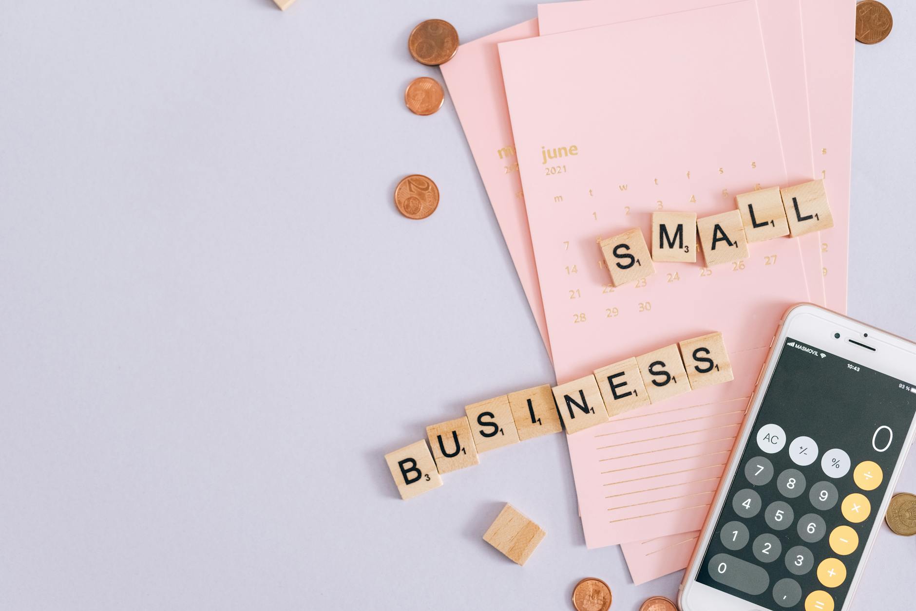 Small business Google Ads budget planning tools including calendar, coins and smartphone calculator