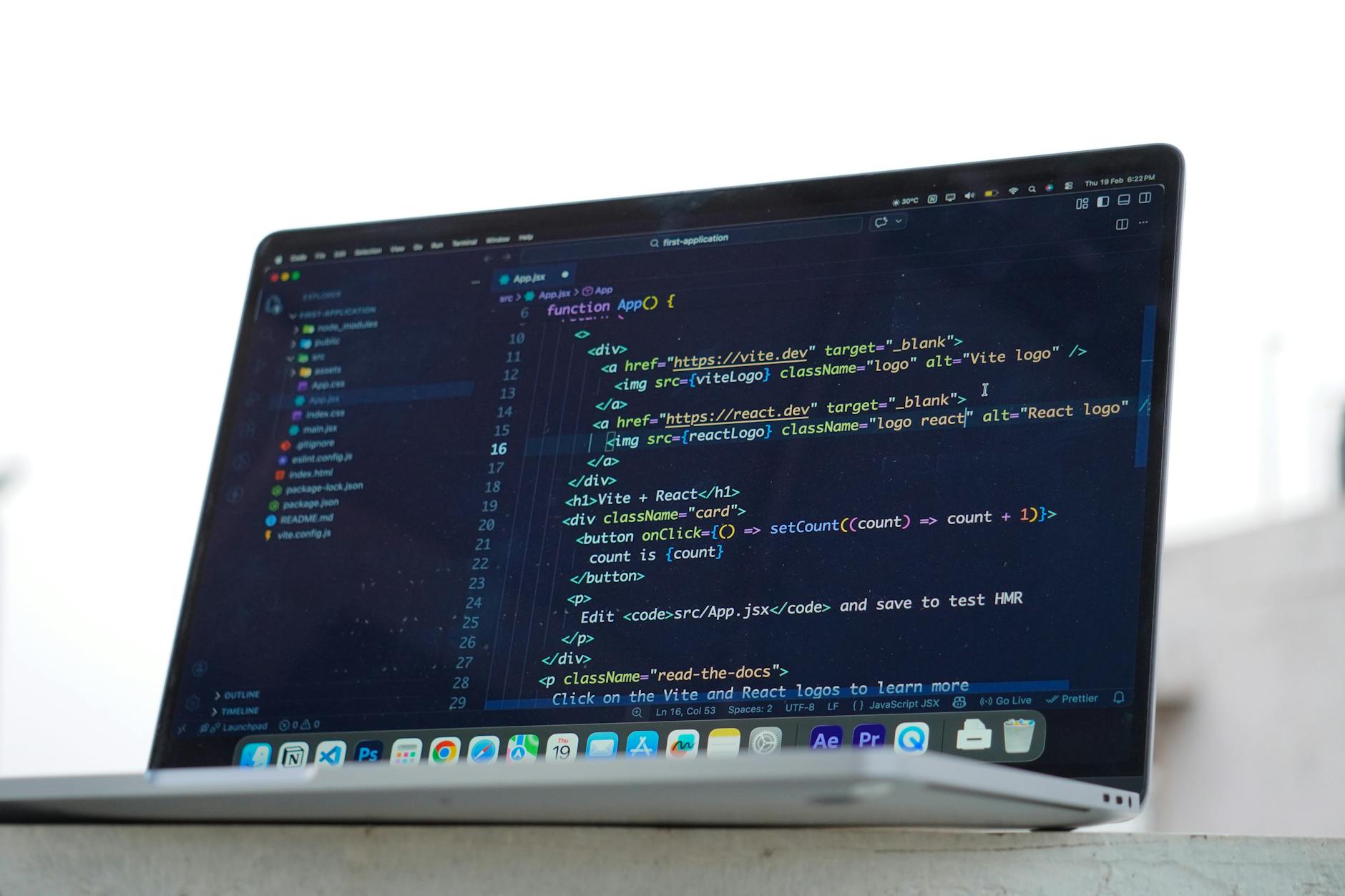 Developer coding on laptop comparing React and WordPress frameworks for small business websites
